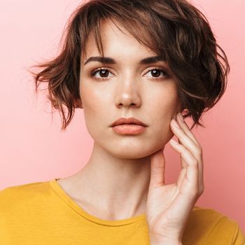 A woman with short feathered hair.