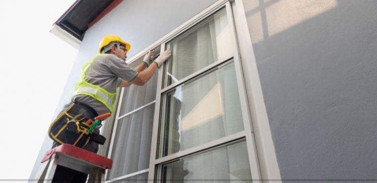 A man replacing an exterior window on a house.